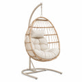 Fauteuil suspendu en rotin synthétique avec coussin beige, structure acier